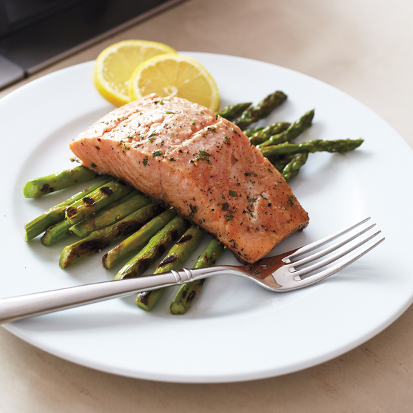 Gourmet Grilled Delight: Tender and Juicy Salmon Graced with Perfectly Grilled Asparagus Spears, Elevating Your Palate with a Symphony of Flavors.